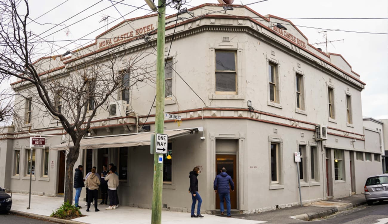 Patrons entering the Mona Castle Hotel bar from the corner entrance in Seddon.