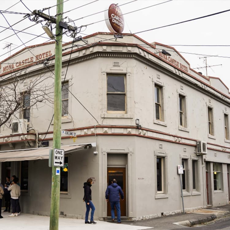 Patrons entering the Mona Castle Hotel bar from the corner entrance in Seddon.